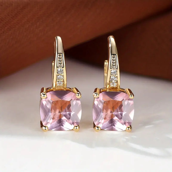 Gold hoop earrings with mystic sapphire