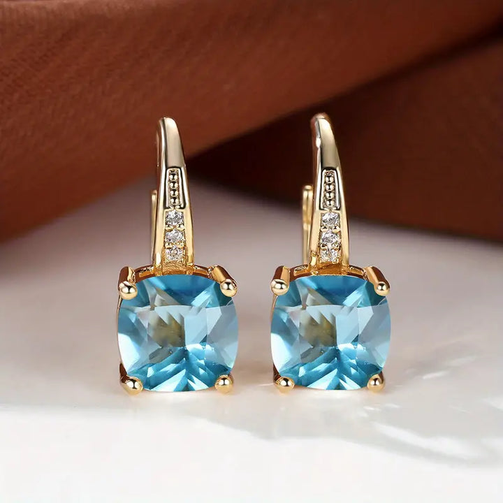 Gold hoop earrings with mystic sapphire