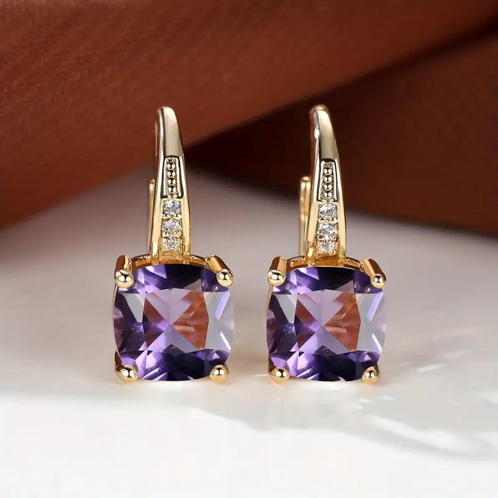 Gold hoop earrings with mystic sapphire