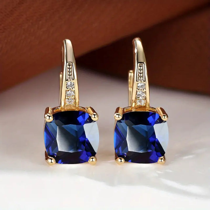 Gold hoop earrings with mystic sapphire
