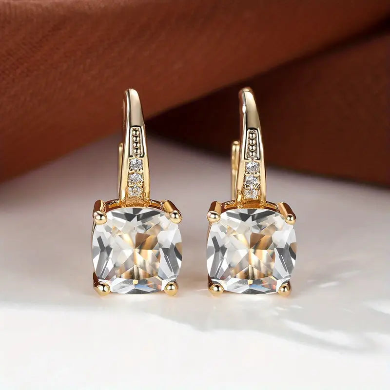Gold hoop earrings with mystic sapphire