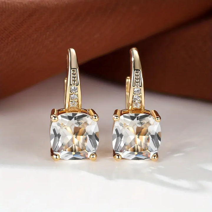 Gold hoop earrings with mystic sapphire
